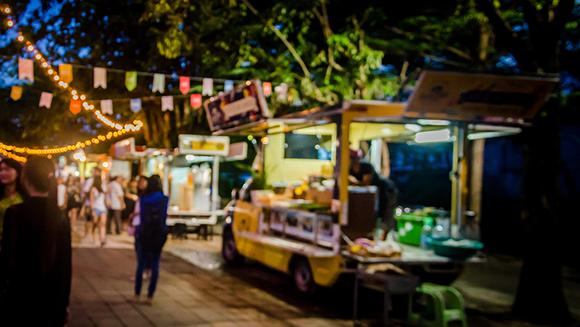 a street food stall at a fair in the evening